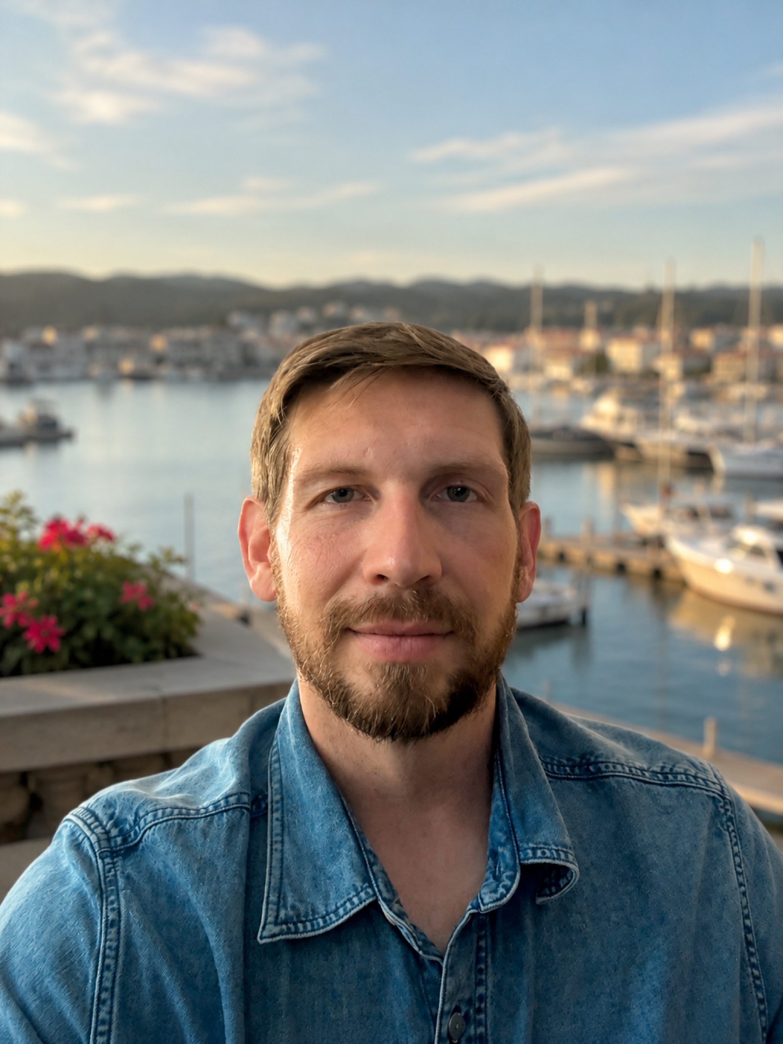 Zac Henson beside a harbor in Orange County